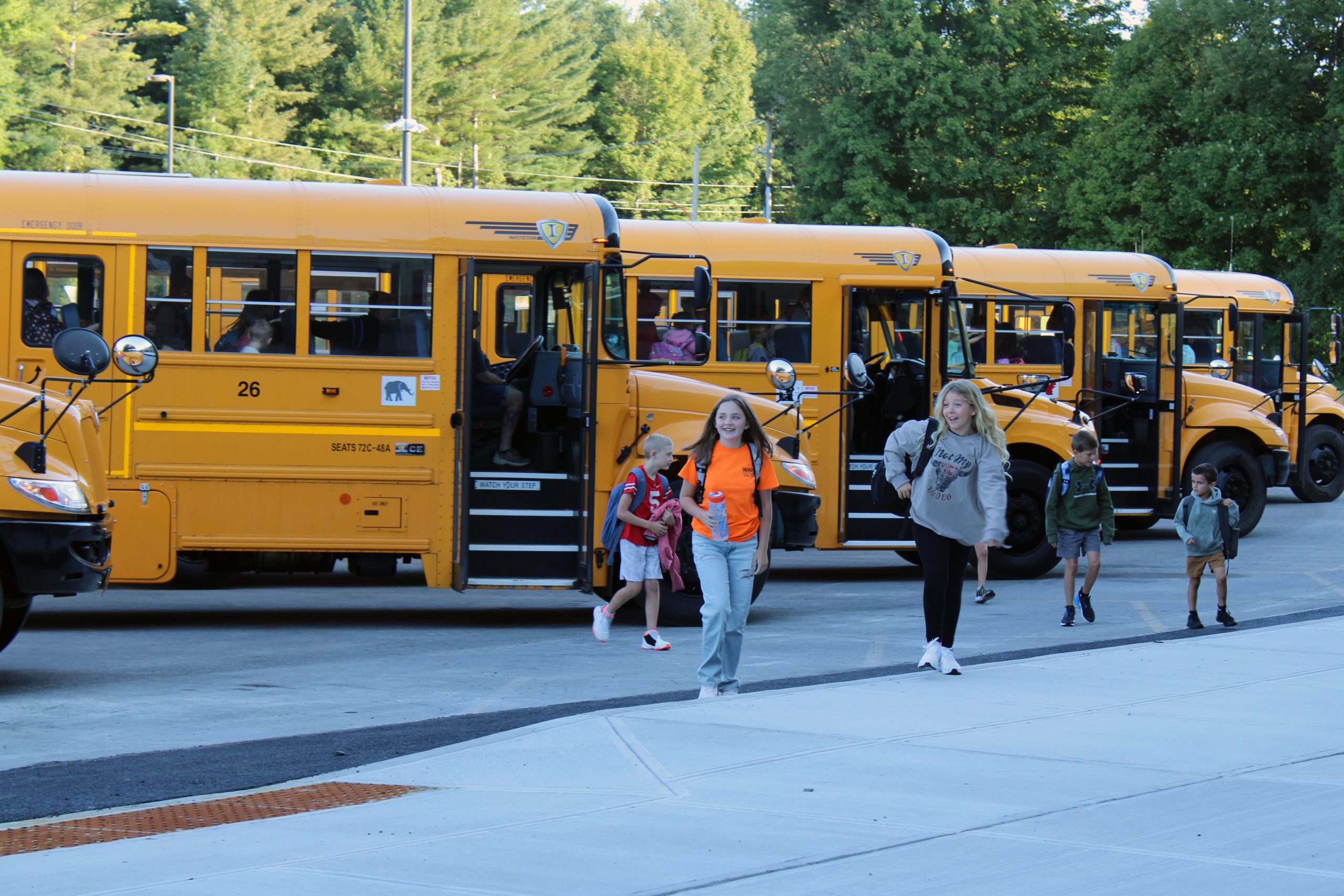 students getting off the bus
