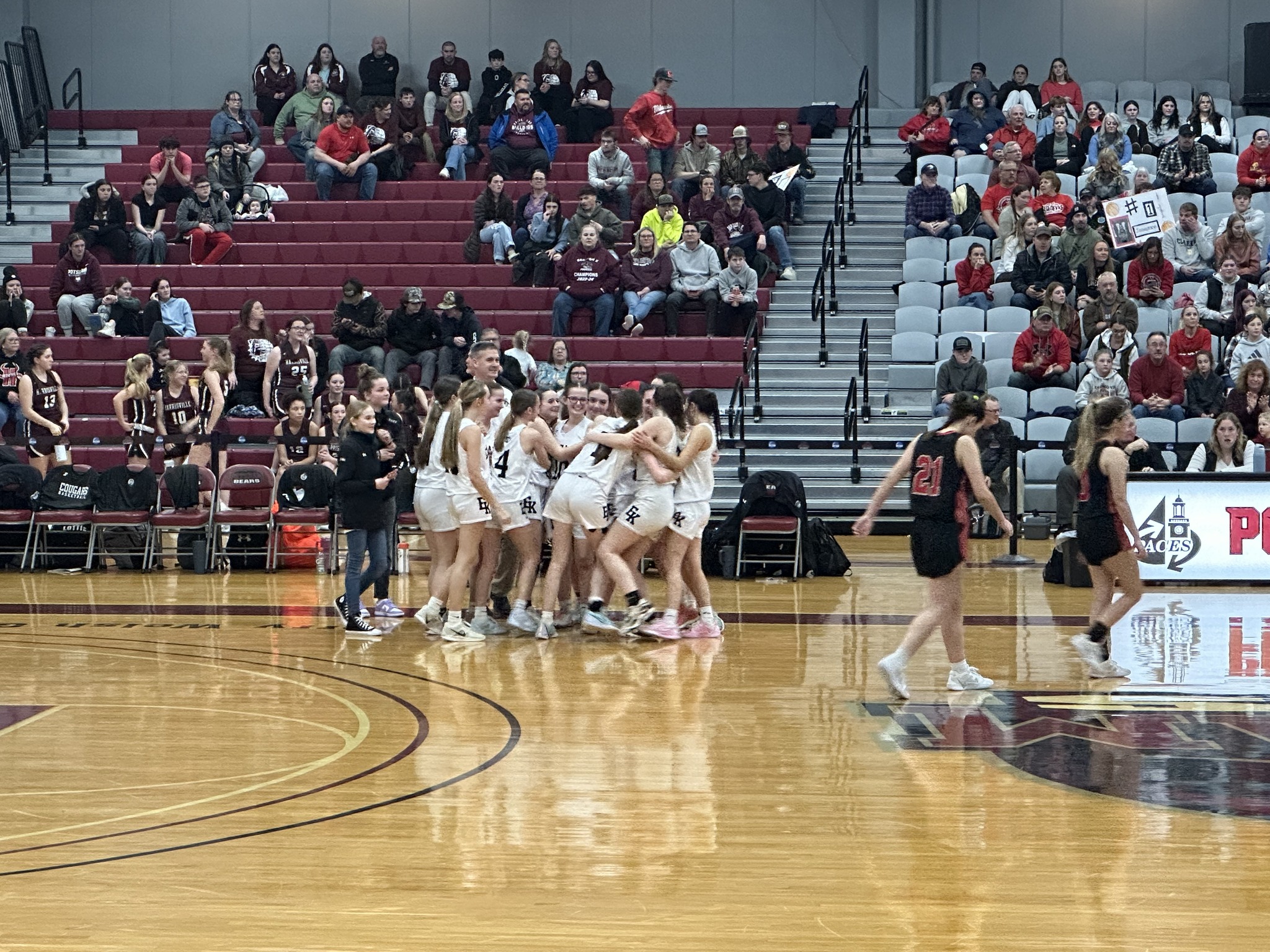 students grouping together to celebrate in basketball game