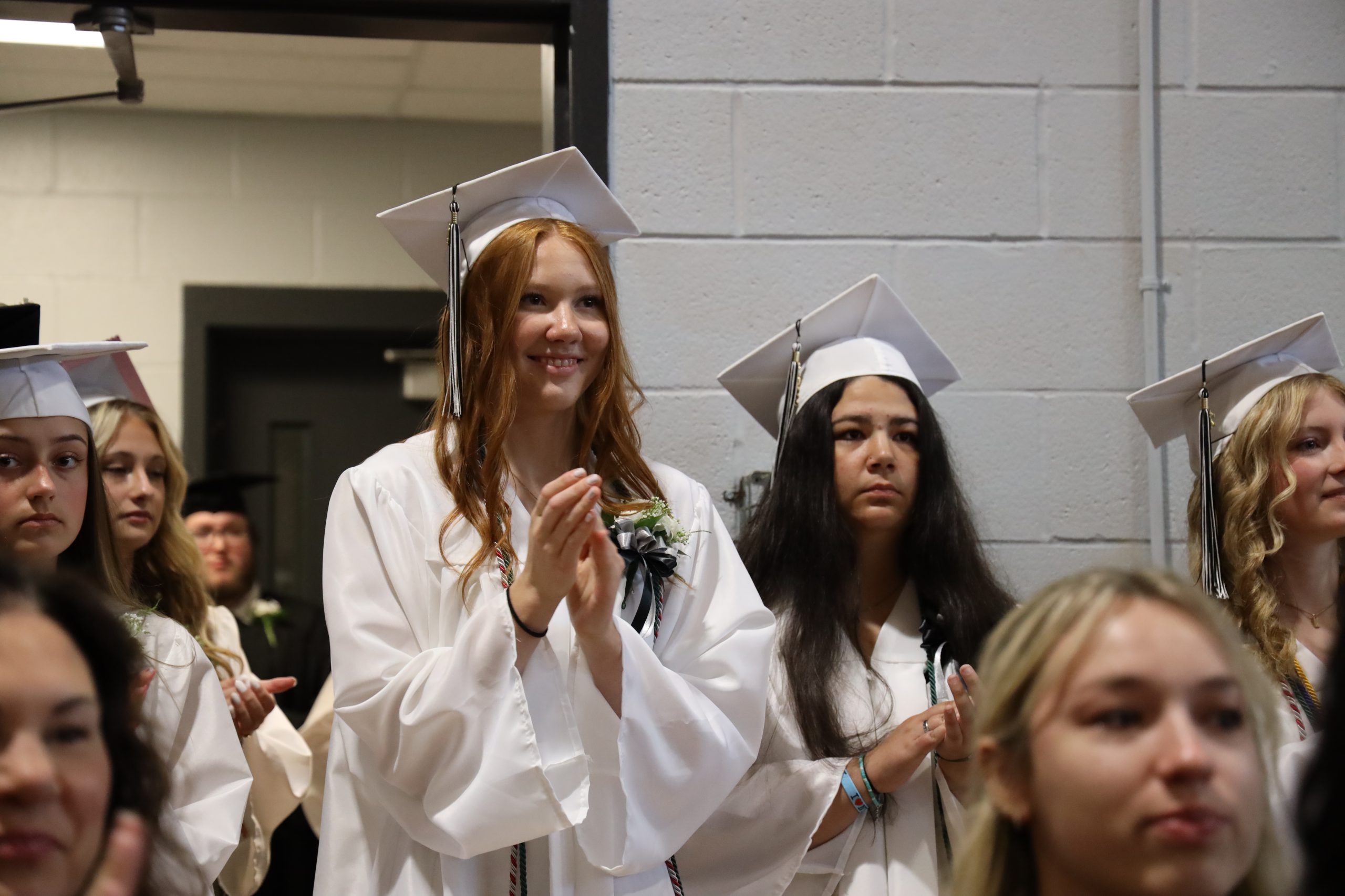 high school students in graduation outfits