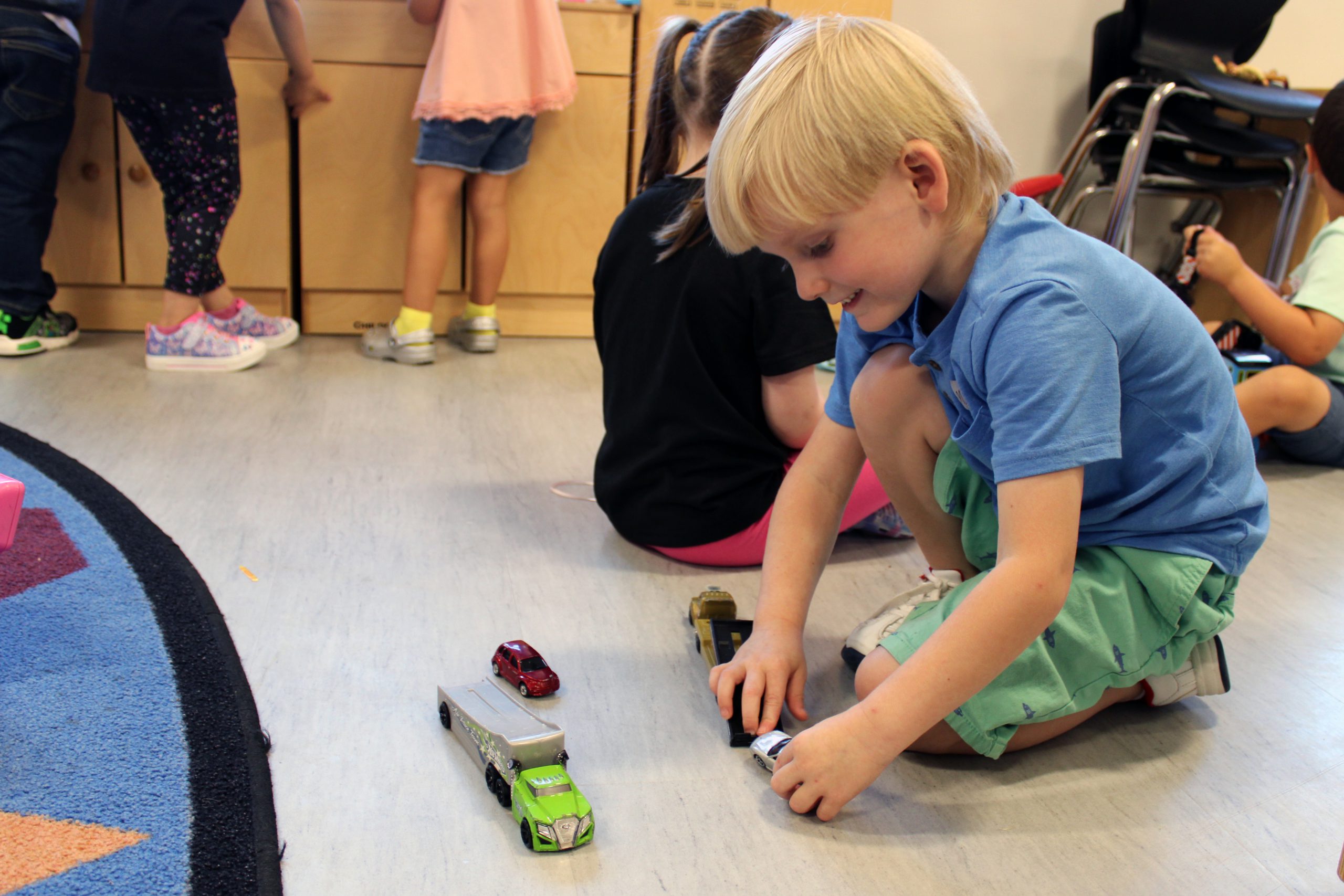 young student playing with toys