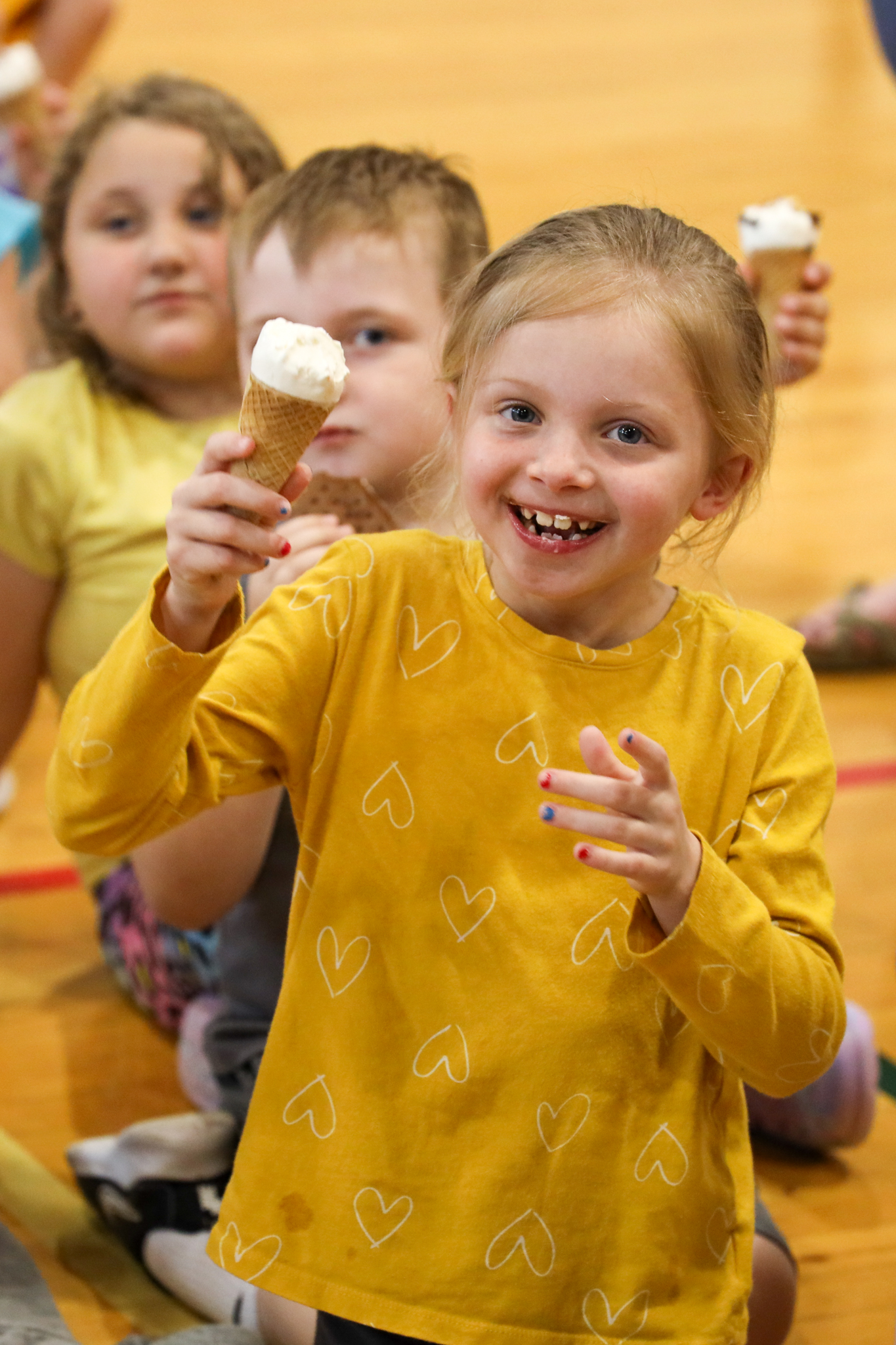 A student holding up an ice cream cone