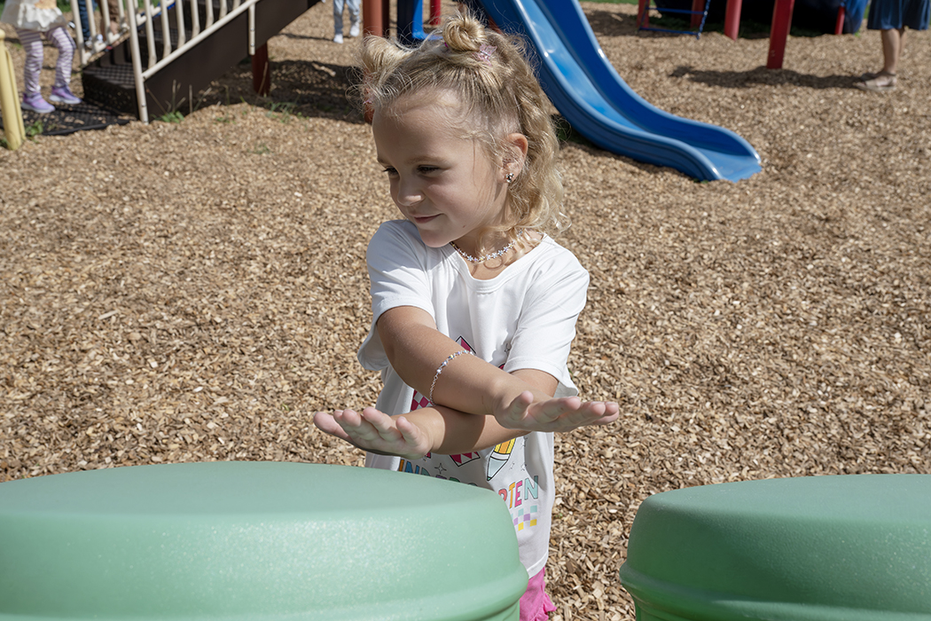 A student plays outside on the playground.